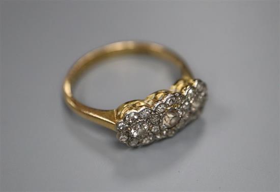 An 18ct yellow and white gold diamond triple cluster ring, size L/M, gross 2.7g